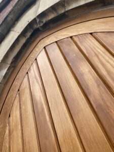 Detailed joinery showing precision curved work on bespoke arched timber door.
