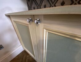 Close up of bespoke alcove cabinet doors with chrome pull knobs in Lincoln