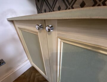 Close up of bespoke alcove cabinet doors with chrome pull knobs in Lincoln