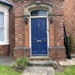 Victorian front door installed within brick arch at listed property in Nettleham