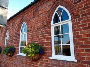 arched timber windows installed in a traditional brick property in Lincoln