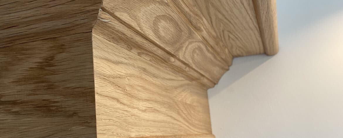 Detailed shaped oak bracket and moulded profile on extractor hood surround