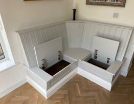 Corner bench seat with lift up storage sections open showing internal space