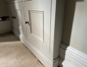 Close up detail of shaker style fitted TV unit with spray painted finish in Lincoln