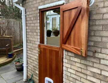 Sapele stable door with top section open and brass ironmongery