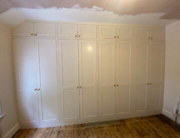 Bespoke fitted wardrobes built into angled ceiling space in Canwick Lincoln.