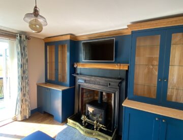 Living room fireplace and empty alcoves before the bespoke media unit was fitted in Branston Booths.