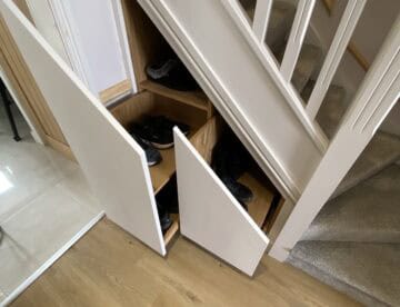Two bespoke pull-out under-stairs storage drawers open beneath the staircase in Skellingthorpe.