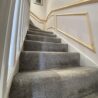 Bespoke timber panelling following the slope and proportions of the staircase.