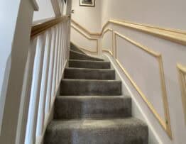 Decorative timber wall panelling following the shape of a staircase in Skellingthorpe.