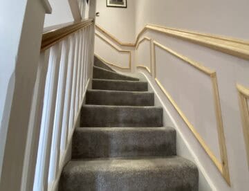 Decorative timber wall panelling following the shape of a staircase in Skellingthorpe.